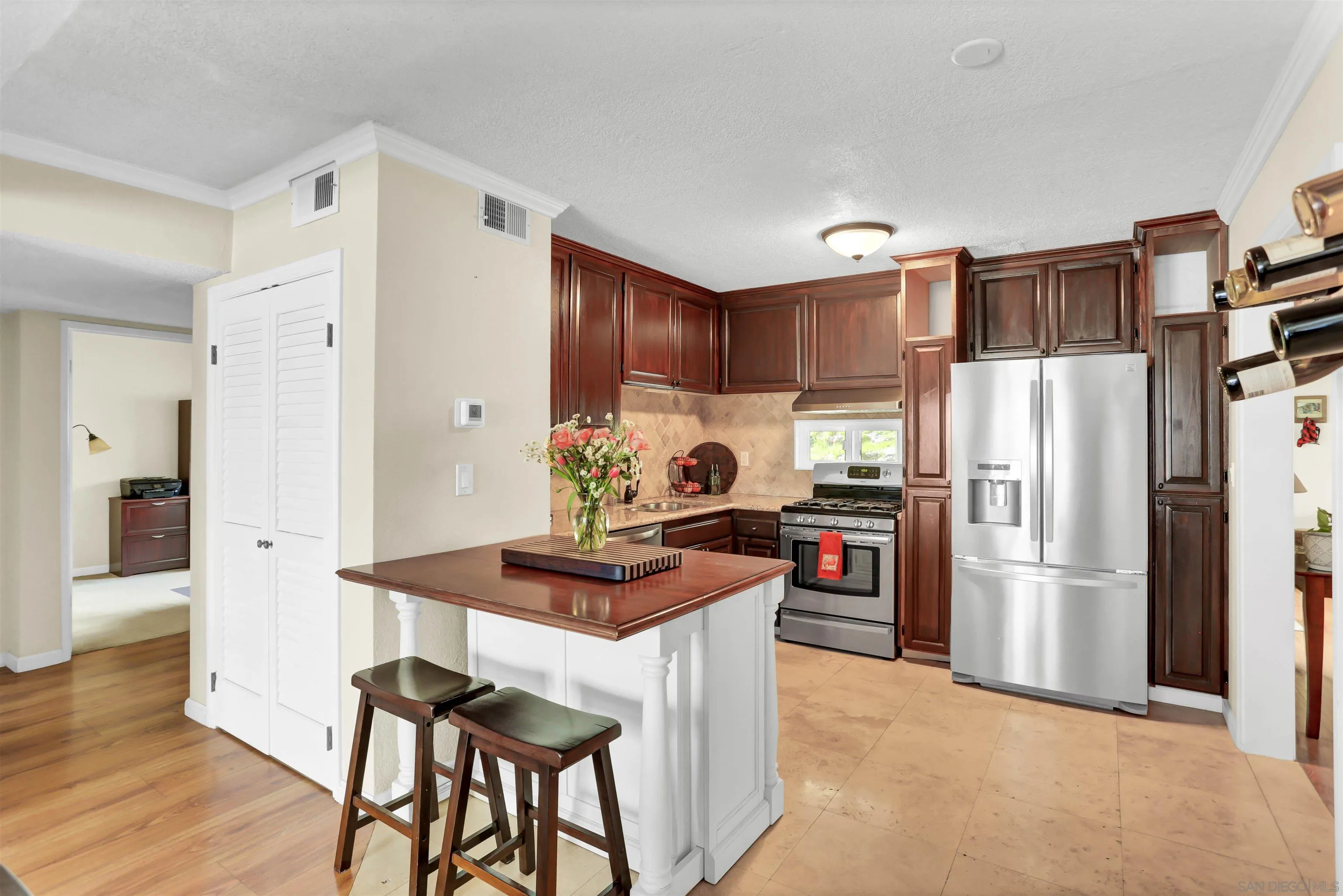 8009 Shantung Drive Santee, CA 92071 - Photo 5 of 39 a kitchen with stainless steel appliances a refrigerator and a stove