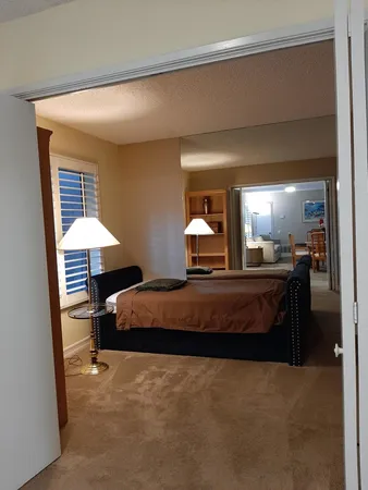 a bedroom with a bed and lamp