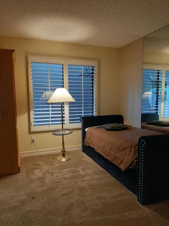 a bedroom with a bed and a table