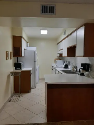 a kitchen with stainless steel appliances a sink stove and refrigerator