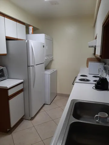 a kitchen with a refrigerator and a stove