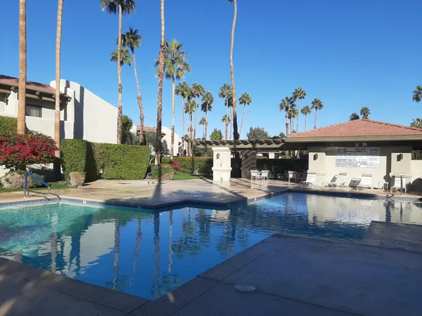 a view of swimming pool with outdoor seating