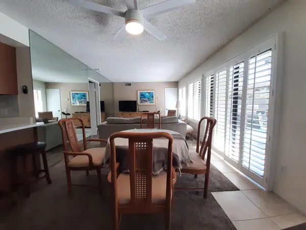 a view of a dining room with furniture and a window