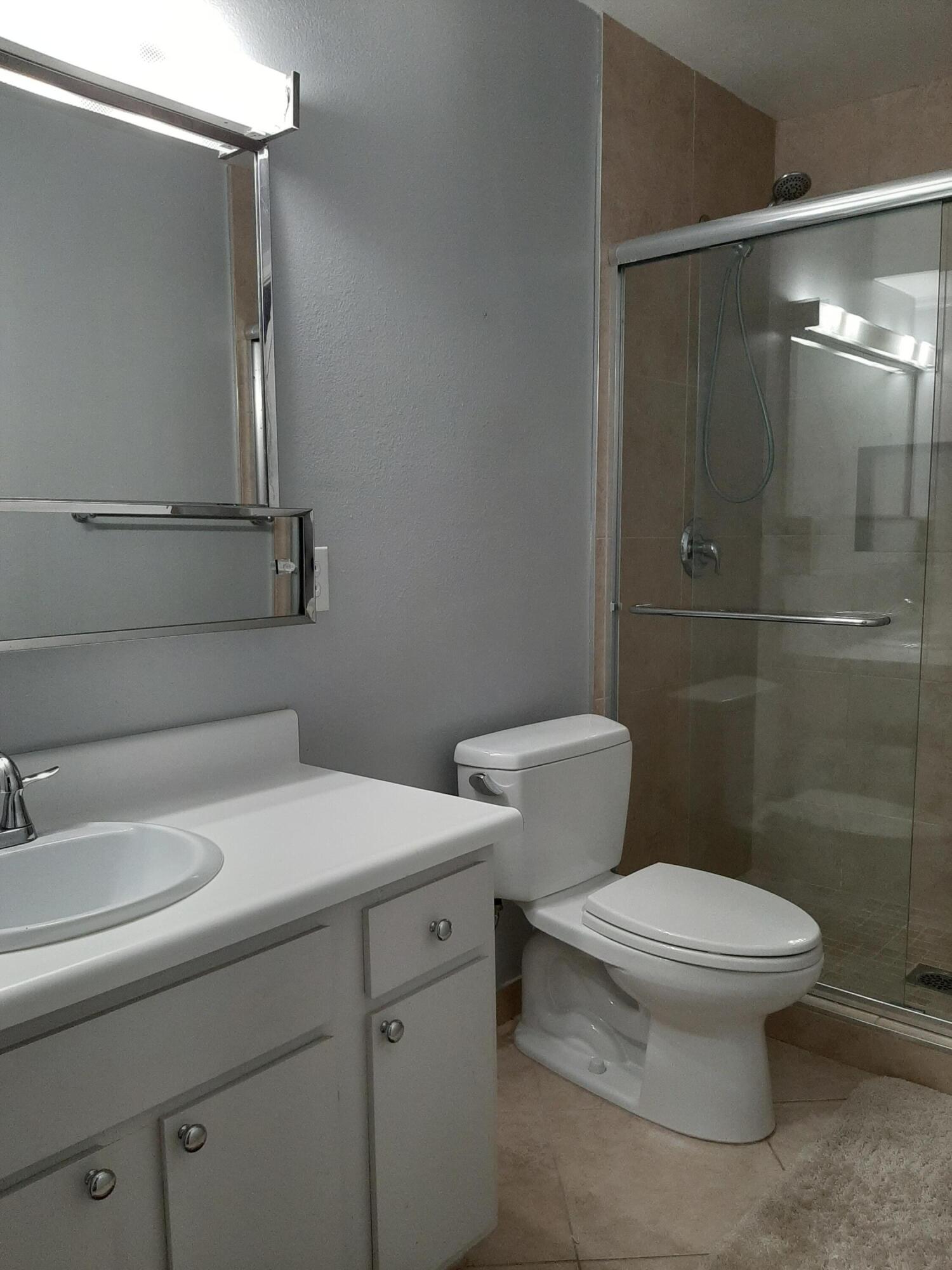1100 East Amado Road, Unit 14D1 Palm Springs, CA 92262 - Photo 5 of 18 a bathroom with a sink a toilet and shower
