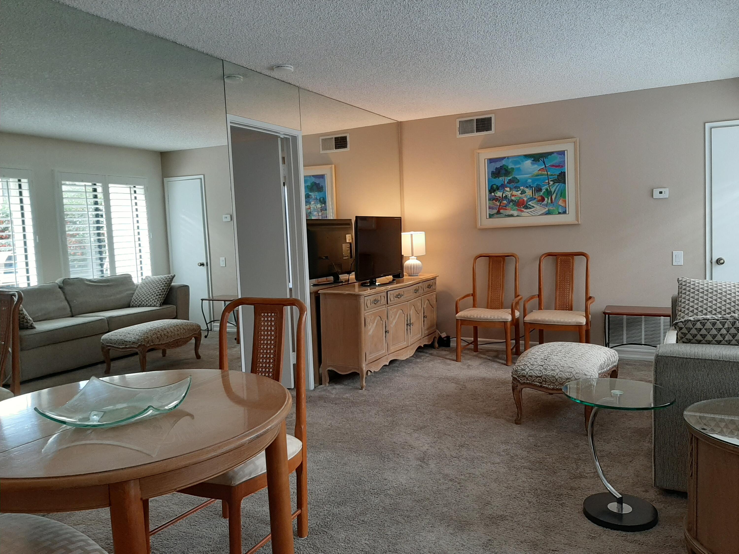 1100 East Amado Road, Unit 14D1 Palm Springs, CA 92262 - Photo 7 of 18 a living room with furniture and a flat screen tv