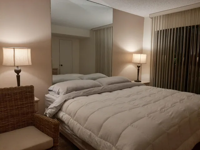 a bedroom with a bed and a lamp