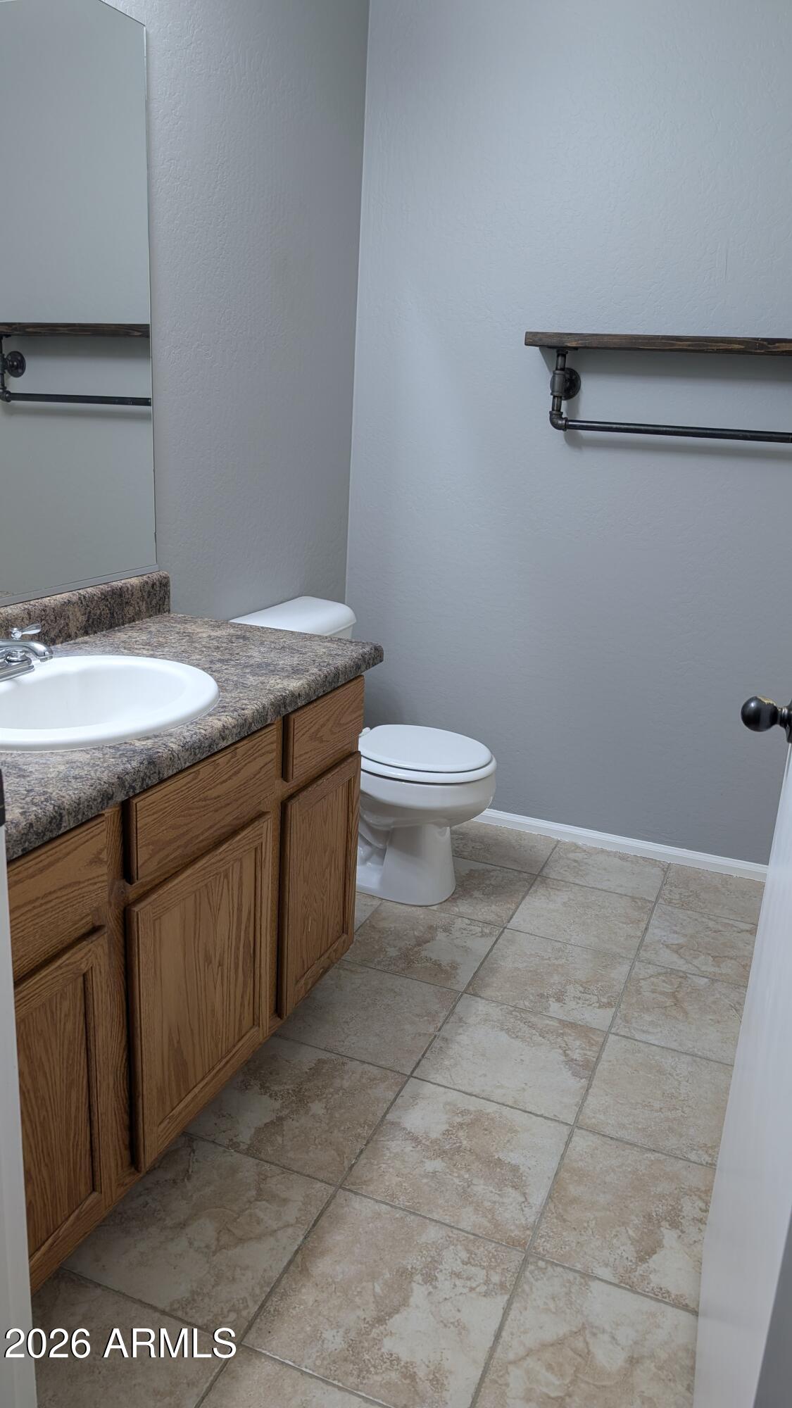1377 East Pryor Road San Tan Valley, AZ 85140 - Photo 21 of 31 a bathroom with a granite countertop sink a toilet and a mirror