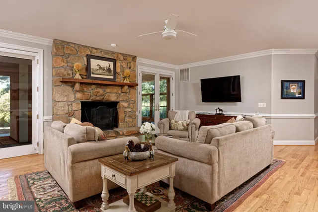 a living room with furniture and large windows