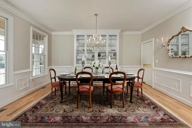 a living room with furniture piano and a bookshelf