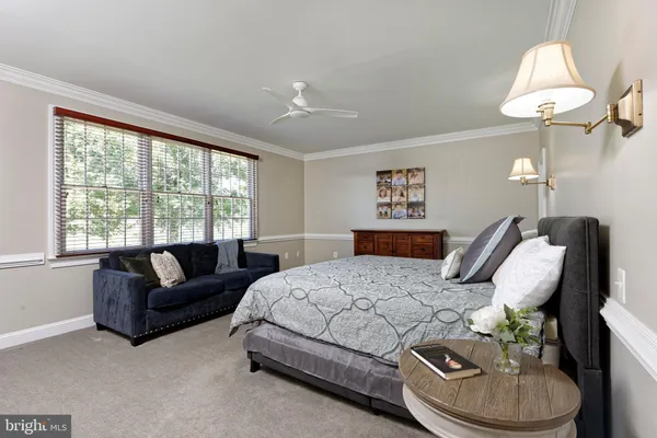 a spacious bedroom with a bed and a large mirror