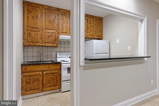 a living room with furniture a flat screen tv and a large window