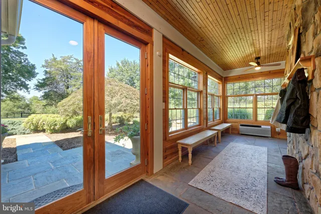 a view of a dining room and livingroom with furniture a rug a kitchen and view