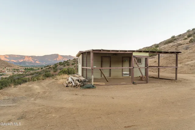 a living room with furniture fireplace and wooden floor