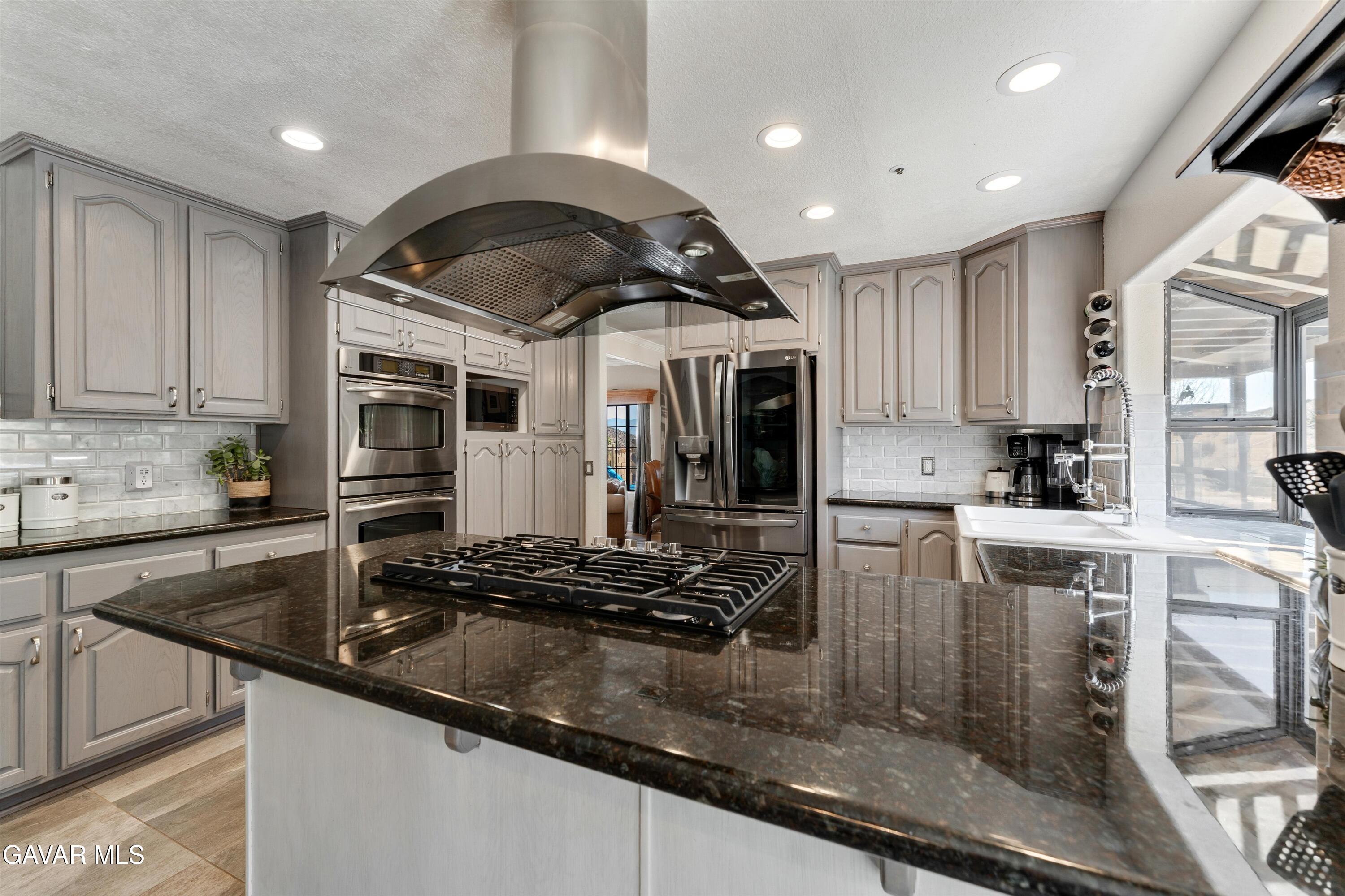 34625 Red Rover Mine Road Acton, CA 93510 - Photo 14 of 66 a kitchen with kitchen island granite countertop a sink stainless steel appliances and cabinets