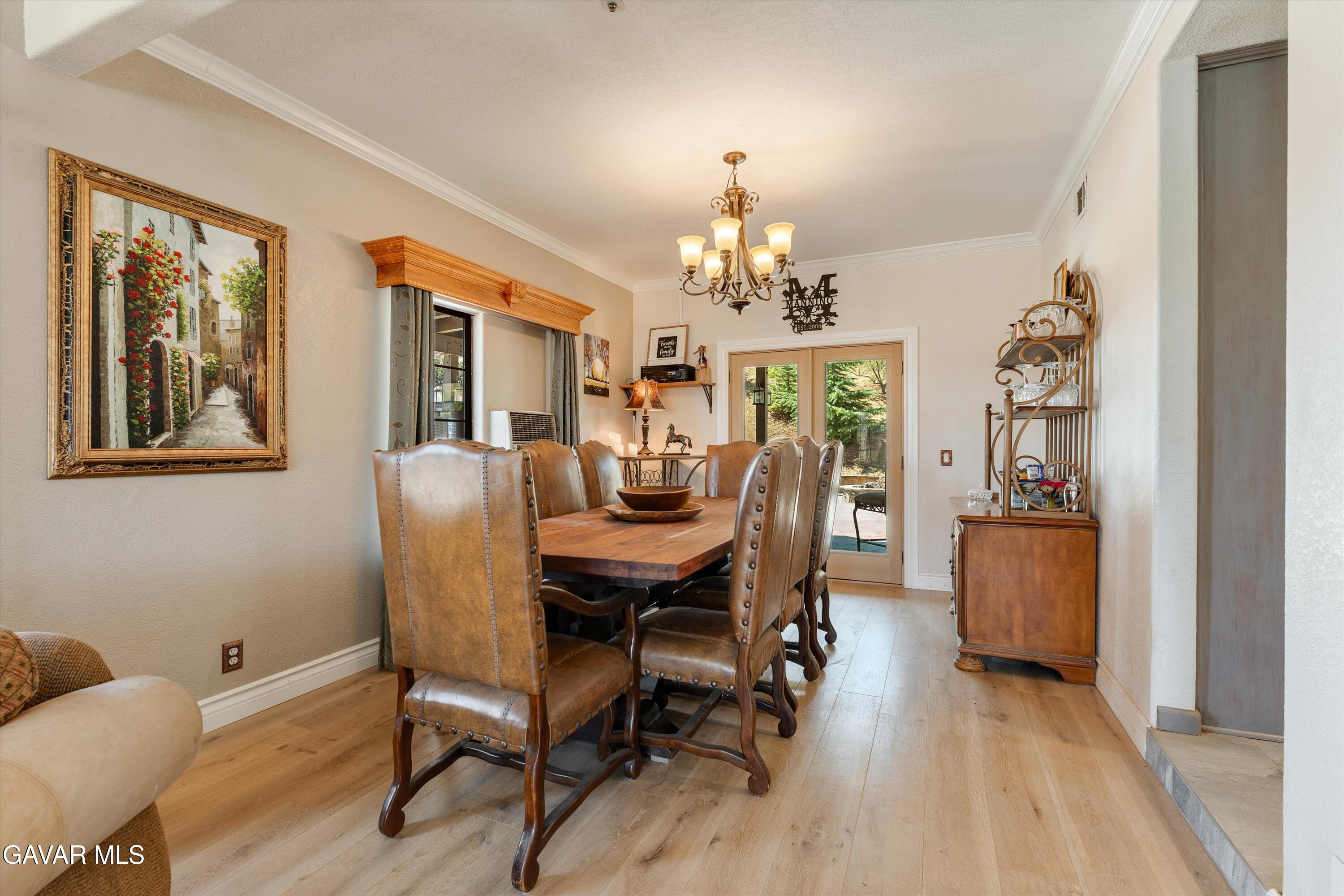34625 Red Rover Mine Road Acton, CA 93510 - Photo 20 of 66 a view of a dining room with furniture a chandelier and wooden floor