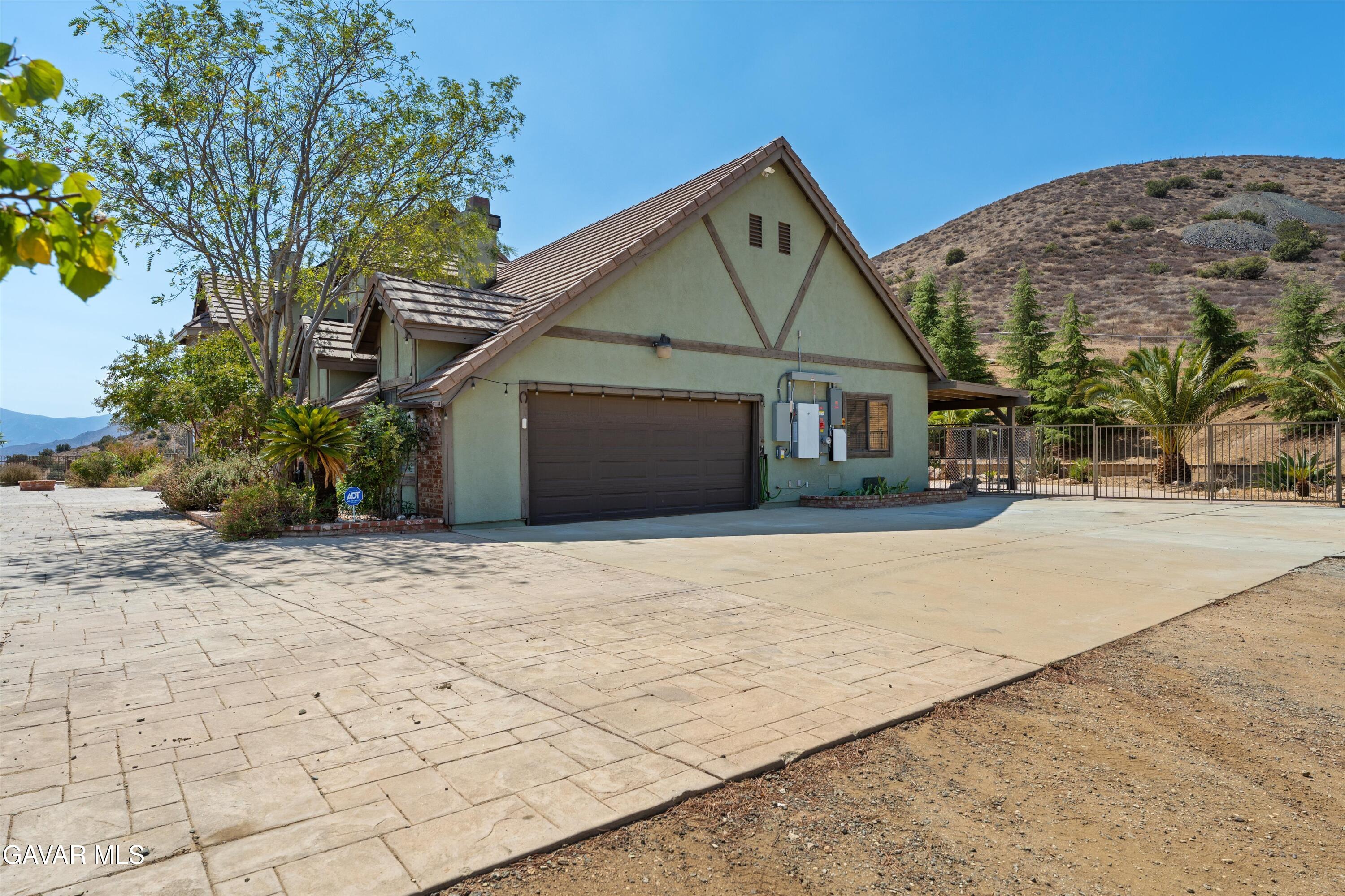34625 Red Rover Mine Road Acton, CA 93510 - Photo 22 of 66 a front view of a house with a yard and garage