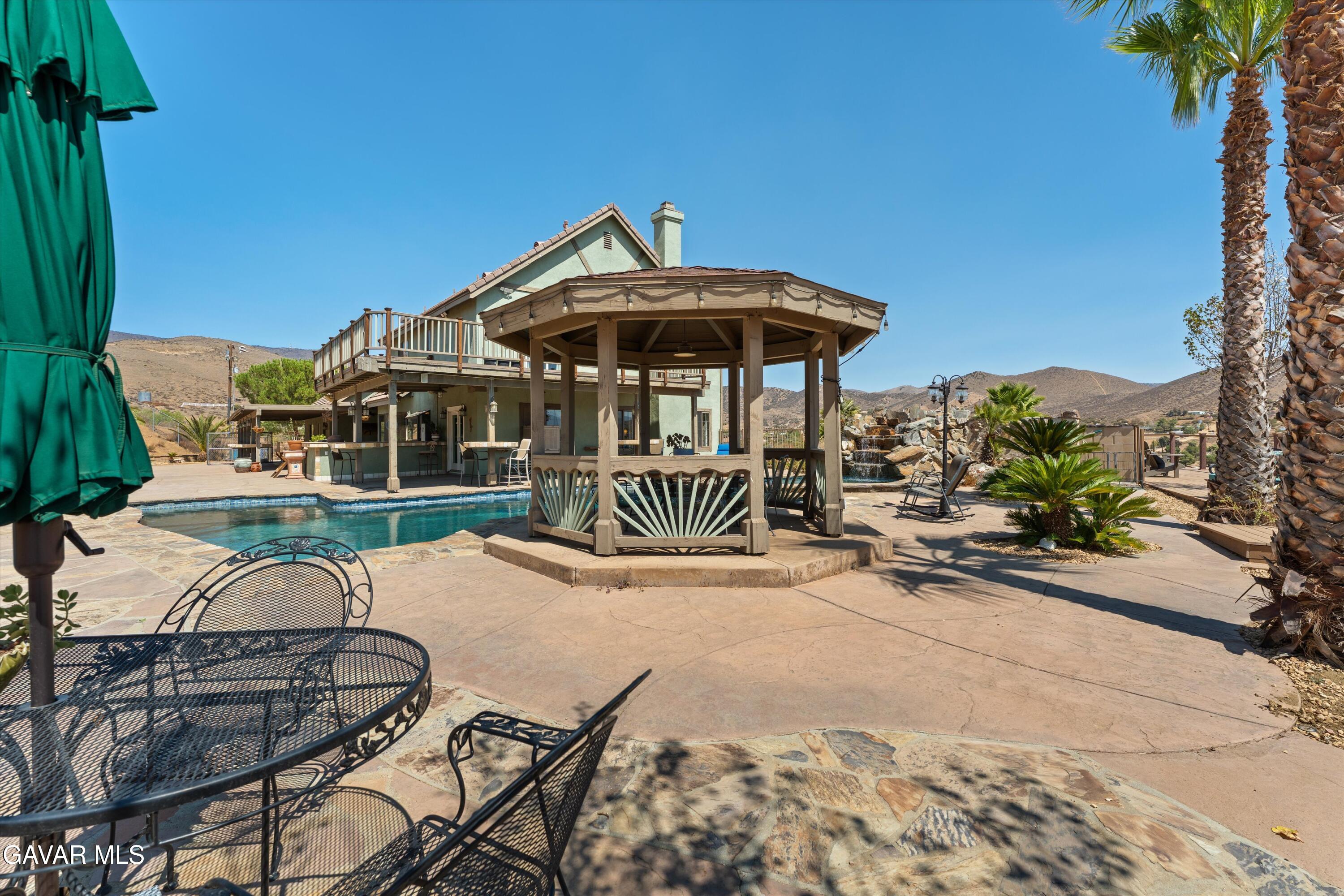 34625 Red Rover Mine Road Acton, CA 93510 - Photo 25 of 66 a view of a patio with a table and chairs under an umbrella