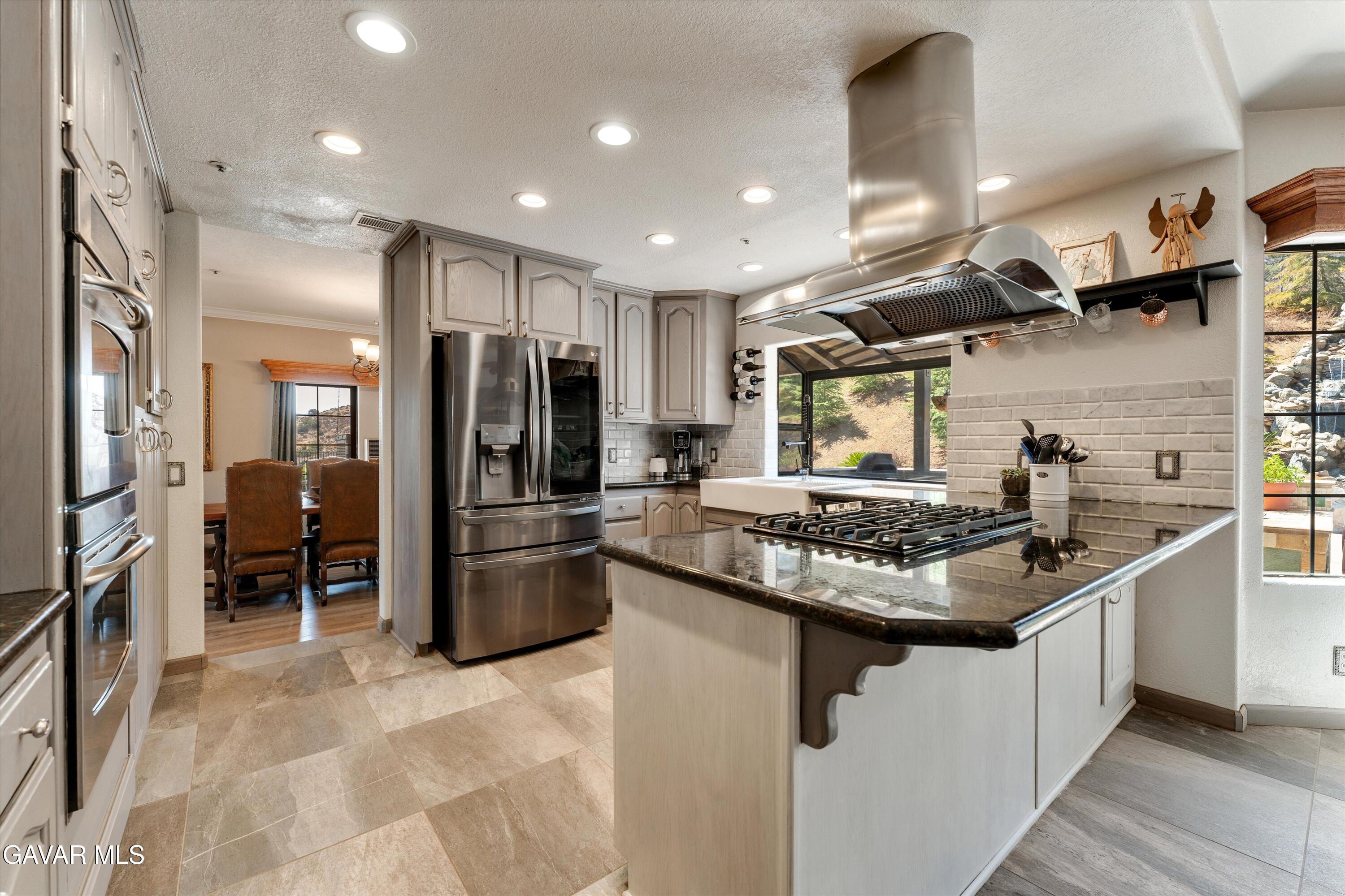 34625 Red Rover Mine Road Acton, CA 93510 - Photo 28 of 66 a kitchen with stainless steel appliances granite countertop a sink stove and refrigerator