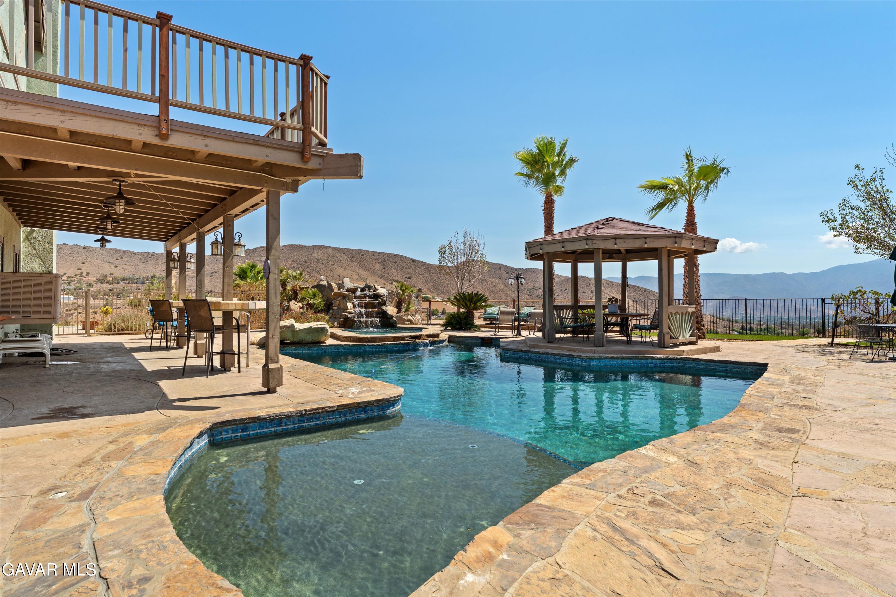34625 Red Rover Mine Road Acton, CA 93510 - Photo 9 of 66 a view of a swimming pool with a table and chairs