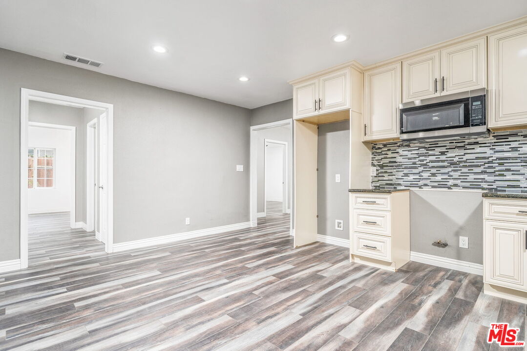 6860 Murray Street Riverside, CA 92504 - Photo 13 of 38 a view of a kitchen with wooden floor and electronic appliances