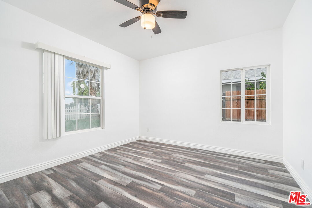 6860 Murray Street Riverside, CA 92504 - Photo 14 of 38 an empty room with windows and fan