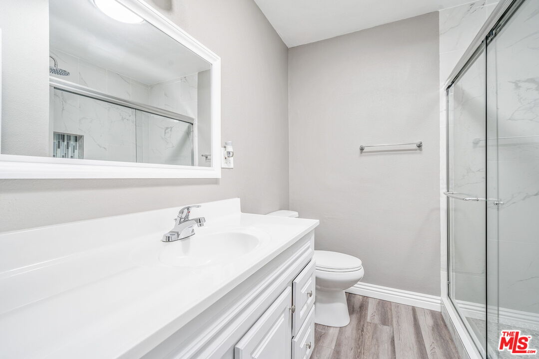 6860 Murray Street Riverside, CA 92504 - Photo 15 of 38 a bathroom with a sink toilet and a mirror