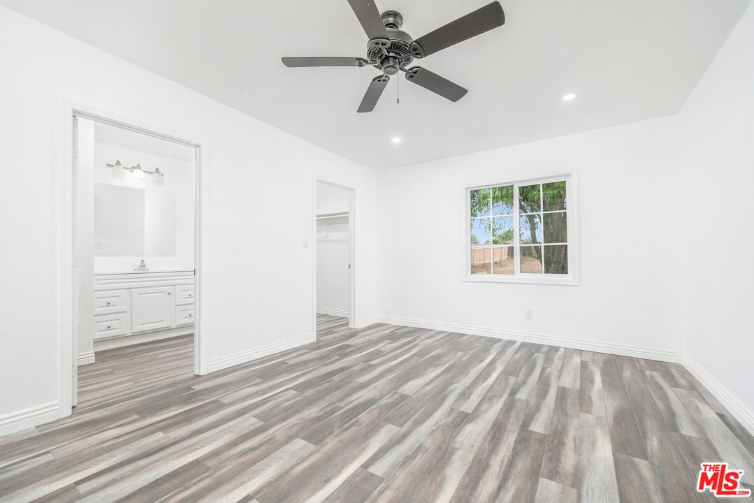 6860 Murray Street Riverside, CA 92504 - Photo 20 of 38 wooden floor in an empty room with a window
