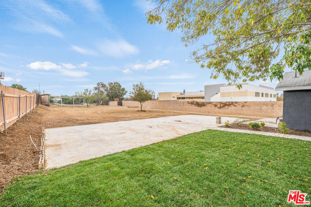 6860 Murray Street Riverside, CA 92504 - Photo 28 of 38 a view of yard with swimming pool and green space