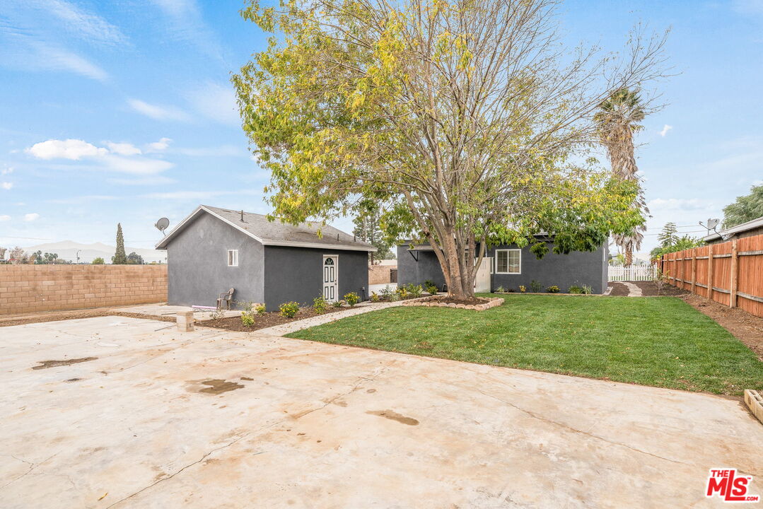 6860 Murray Street Riverside, CA 92504 - Photo 31 of 38 a tree is standing in the yard with wooden fence