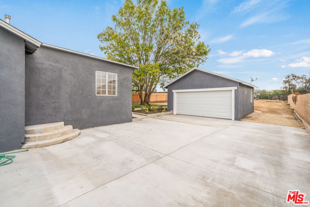 6860 Murray Street Riverside, CA 92504 - Photo 38 of 38 a view of a house with a yard and garage