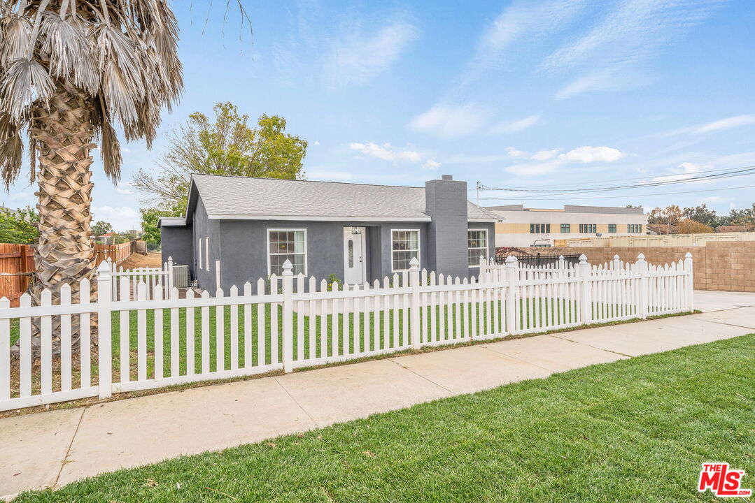 6860 Murray Street Riverside, CA 92504 - Photo 4 of 38 a view of a house with a yard and plants