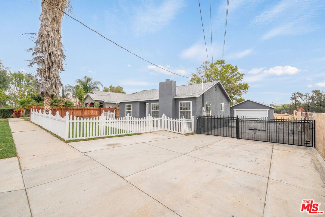 6860 Murray Street Riverside, CA 92504 - Photo 5 of 38 a view of a house with a small yard and wooden fence