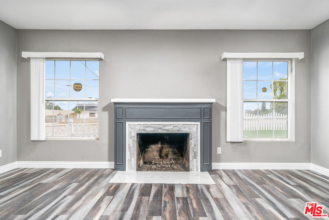 6860 Murray Street Riverside, CA 92504 - Photo 9 of 38 a view of an empty room with a fireplace and a window