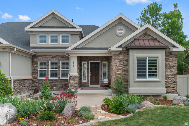 439 East 13540 South Draper, UT 84020 - Photo 44 of 46 Stone veneer and stucco exterior featuring a prominent front entrance with a dark wood door and sidelights