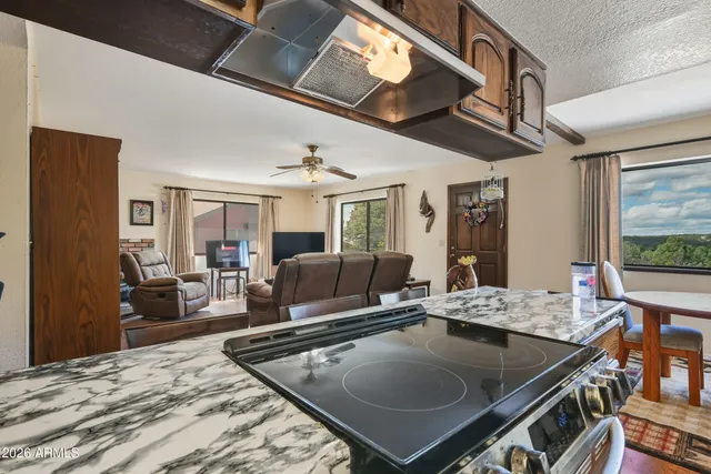 a living room with furniture a flat screen tv and a table
