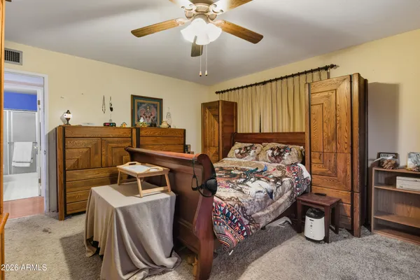a bedroom with bed and window