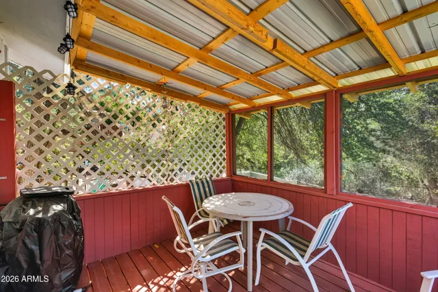 a view of a balcony with table and chairs and wooden floor