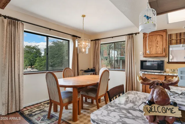 a view of a dining room with furniture window and outside view