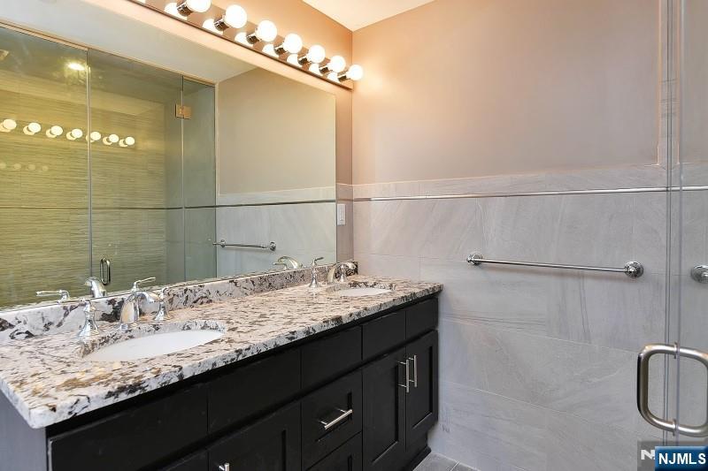 8-10 Whitehall Road, Unit 3 Towaco, NJ 07082 - Photo 6 of 12 a bathroom with a granite countertop sink a toilet and shower