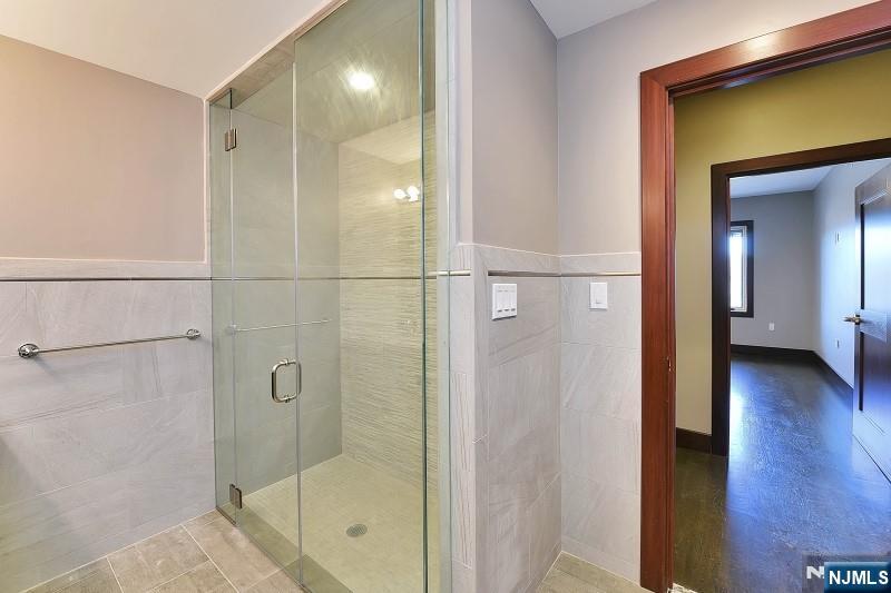 8-10 Whitehall Road, Unit 3 Towaco, NJ 07082 - Photo 7 of 12 a bathroom with a glass shower door and a sink