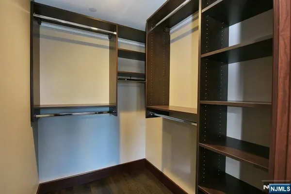 a view of walk in closet with empty racks