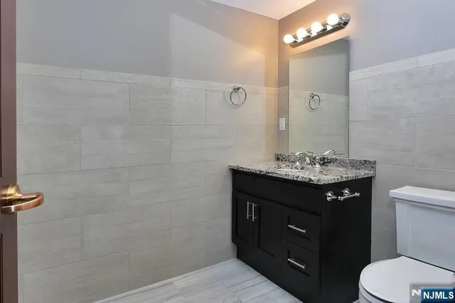 a bathroom with a toilet a sink and mirror