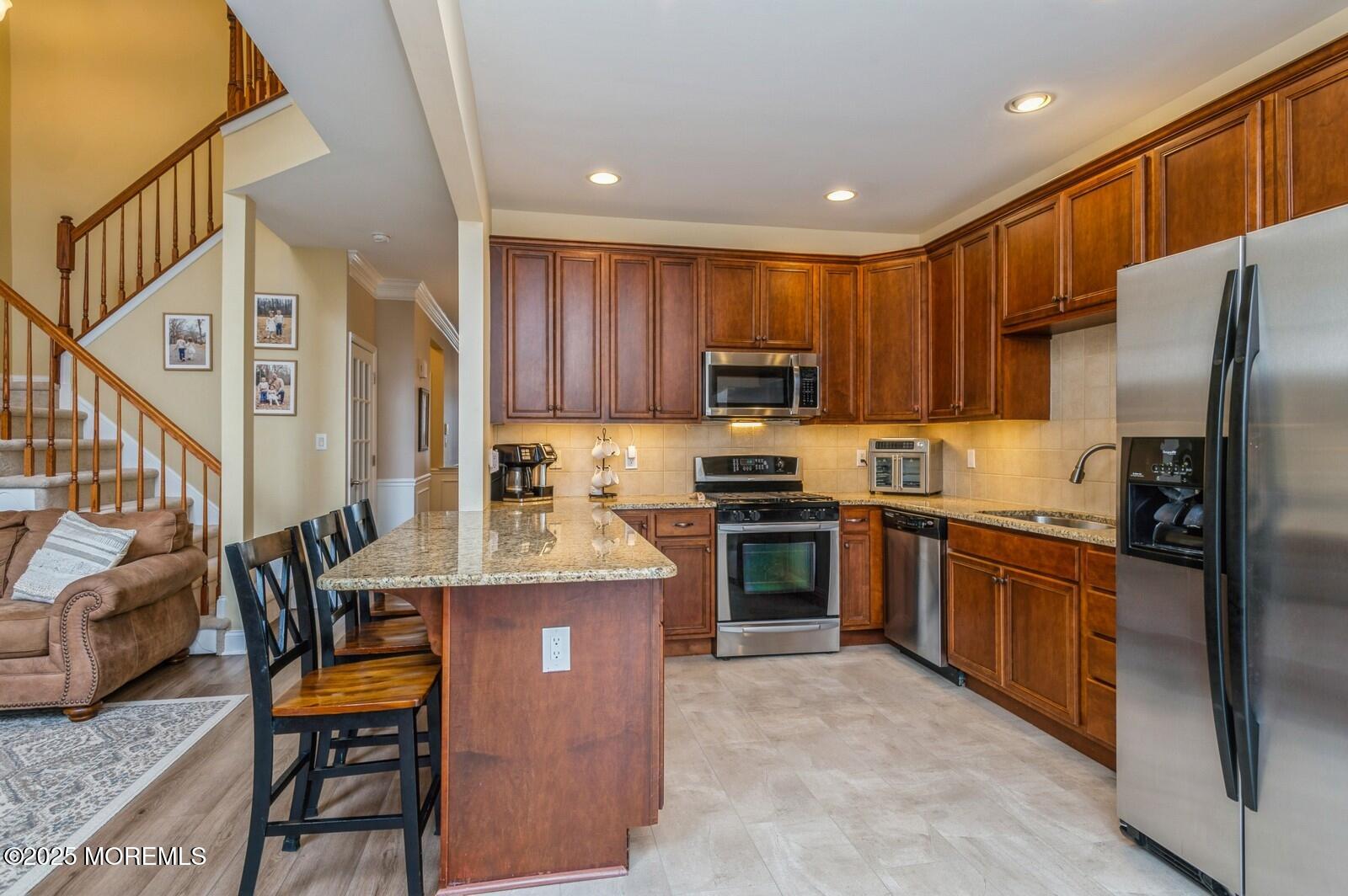 33 Brookfield Drive Jackson, NJ 08527 - Photo 5 of 23 a kitchen with stainless steel appliances granite countertop a refrigerator stove microwave and sink