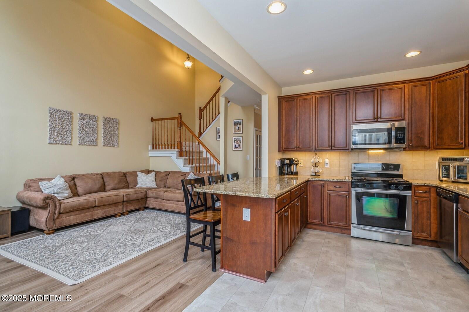33 Brookfield Drive Jackson, NJ 08527 - Photo 6 of 23 a living room with stainless steel appliances furniture a rug and a kitchen view
