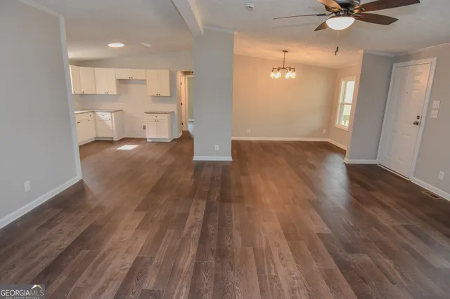 a spacious bathroom with a granite countertop sink and a mirror