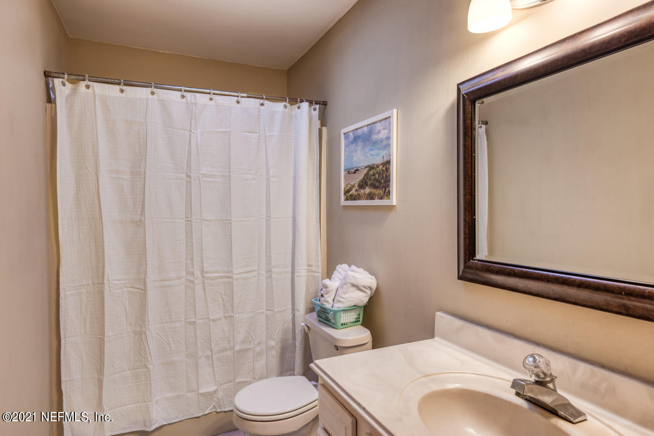 103 Vassar Road St. Augustine, FL 32086 - Photo 21 of 27 a bathroom with a sink a toilet and shower curtain