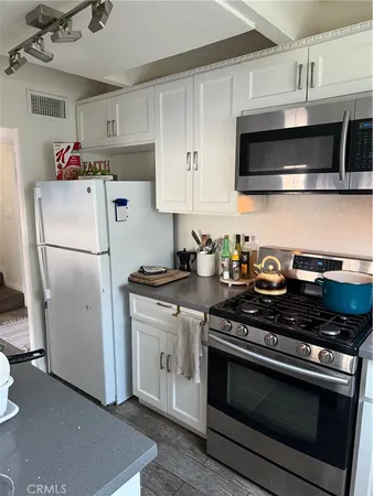 a kitchen with stainless steel appliances a stove a microwave and a refrigerator