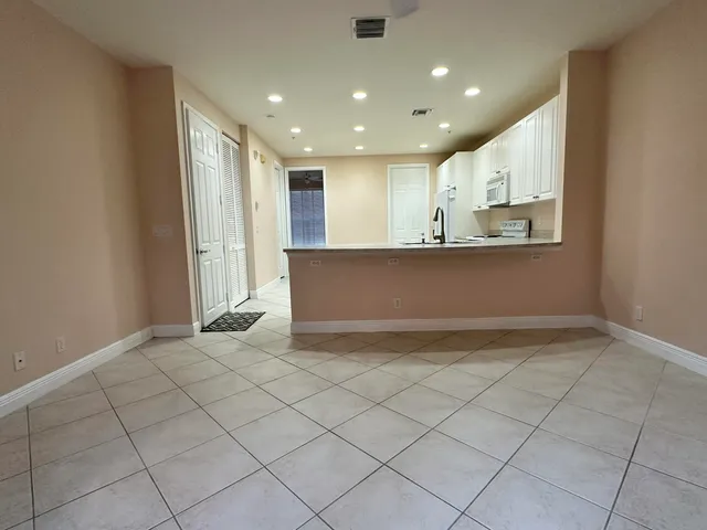 a view of kitchen with granite countertop cabinets