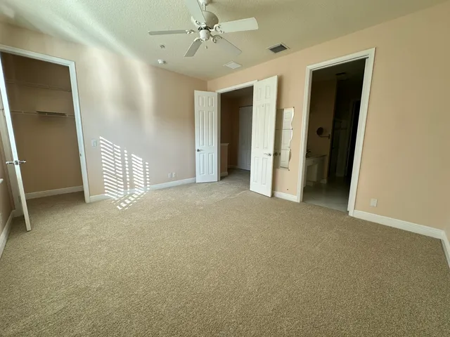 a view of empty room with ceiling fan