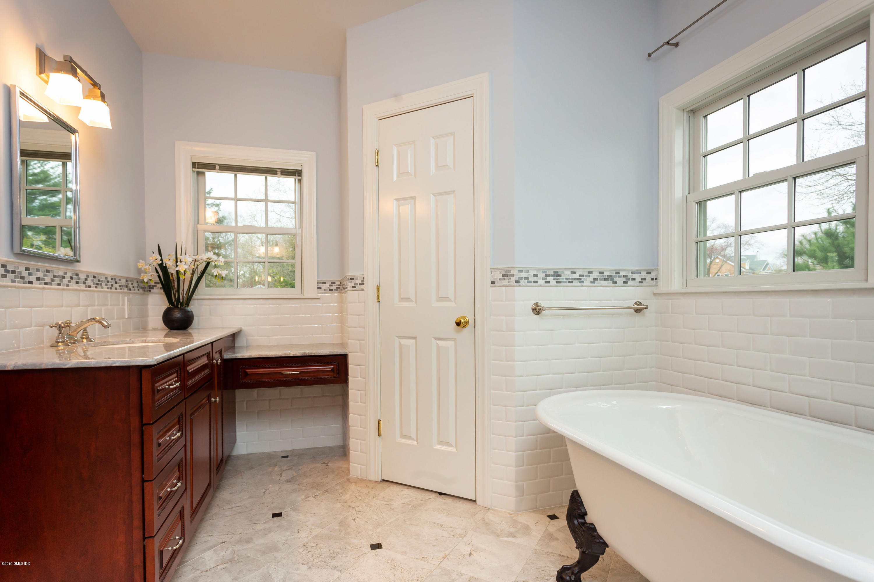 11 Tory Road Riverside, CT 06878 - Photo 17 of 29 a bathroom with a bathtub a sink a window and a shower